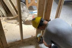 yca-student-fixing-drywall-foundation