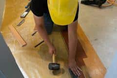 yca-student-hammering-hardwood-floor