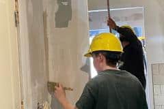 yca-student-painting-corners-drywall