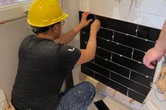 yca-student-putting-up-tiles
