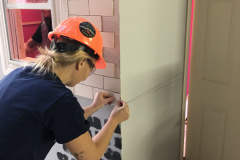 yca-student-fixing-wall-tiles